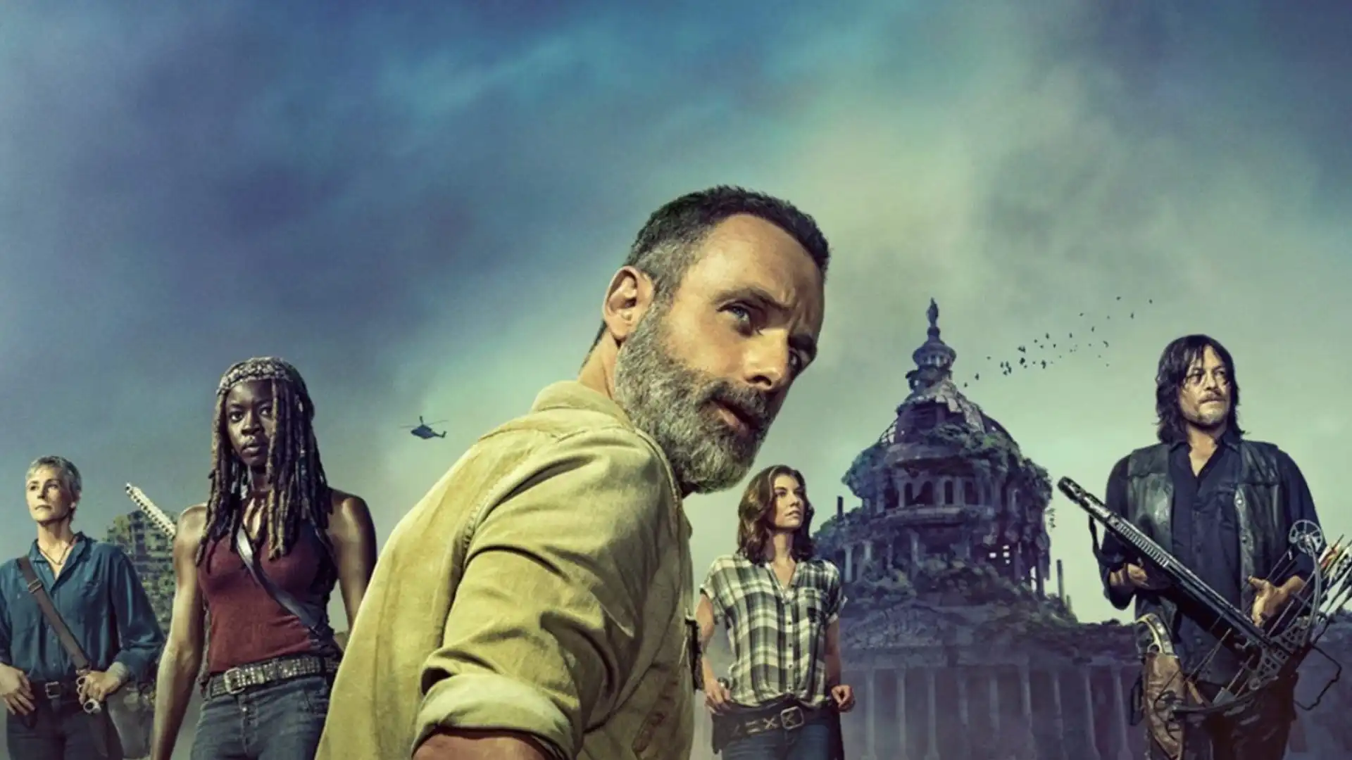 Banner de The Walking Dead com cinco personagens principais e um prédio em ruínas ao fundo.