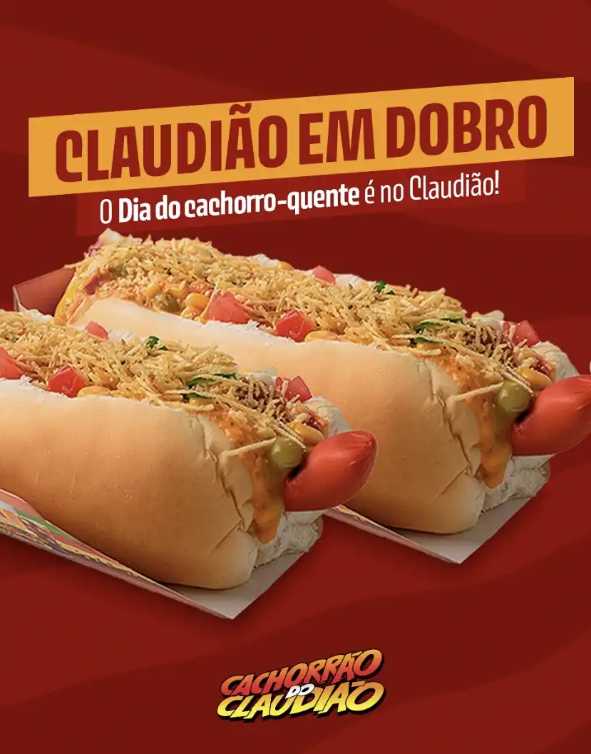 Imagem de propaganda de dois cachorros-quentes em um fundo vermelho com o texto "CLAUDIÃO EM DOBRO" e "O Dia do cachorro-quente é no Claudião!"