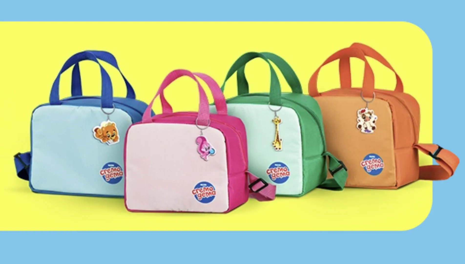 Quatro lancheiras térmicas da Cremogema, nas cores azul, rosa, verde e laranja. Cada lancheira tem um chaveiro de animal.