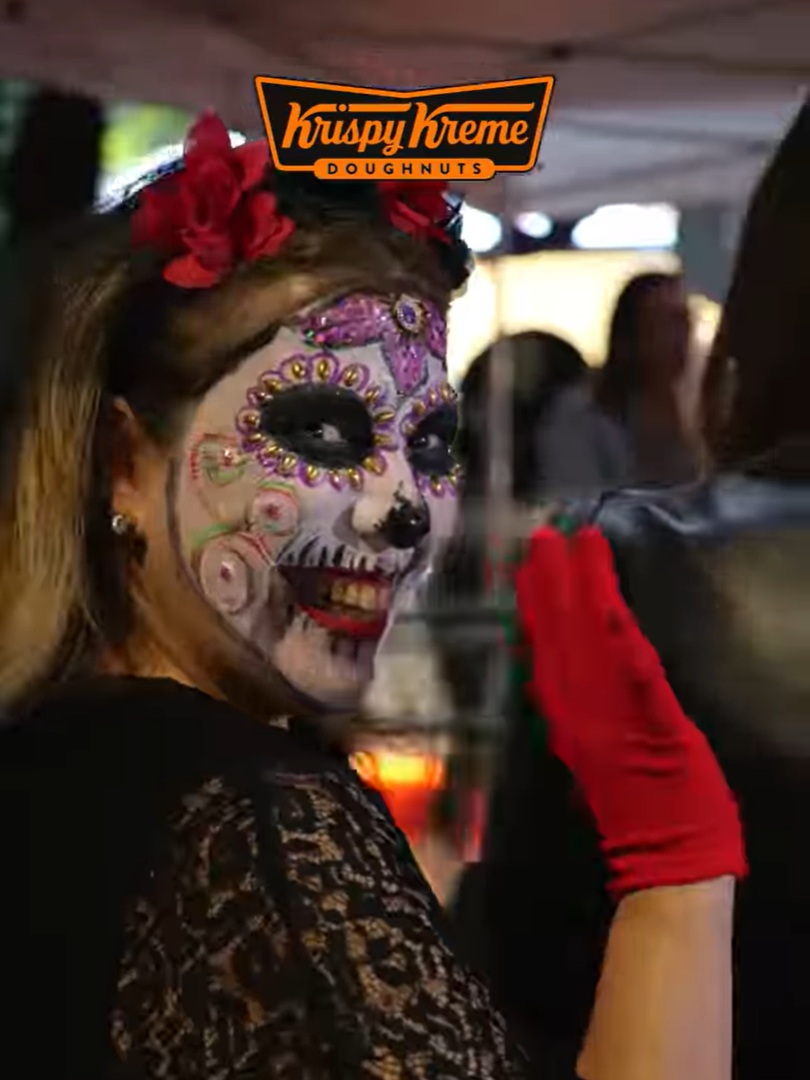 Mulher fantasiada de La Calavera Catrina sorrindo.