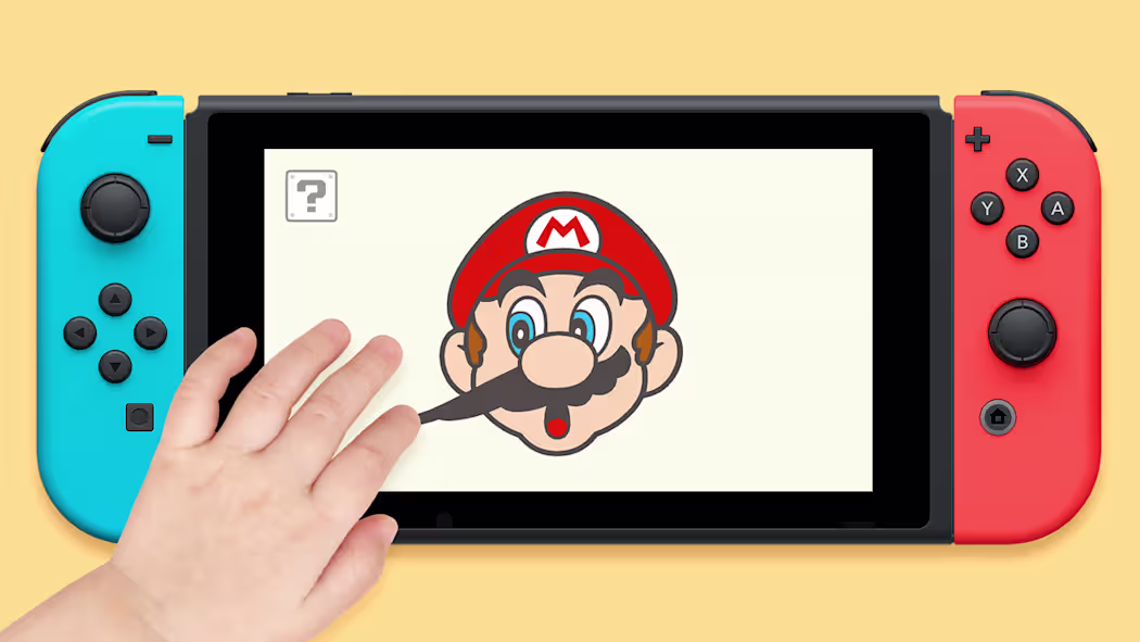 Uma mão de criança interagindo com a tela de um console Nintendo Switch, esticando o bigode de uma ilustração do Mario.