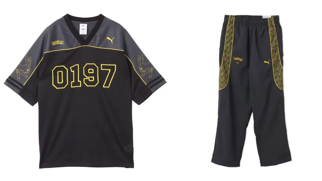 Vista plana de uma camisa de jersey de futebol preta e cinza PUMA x Pokémon com o número "0197" em amarelo, combinada com calças esportivas pretas combinando.