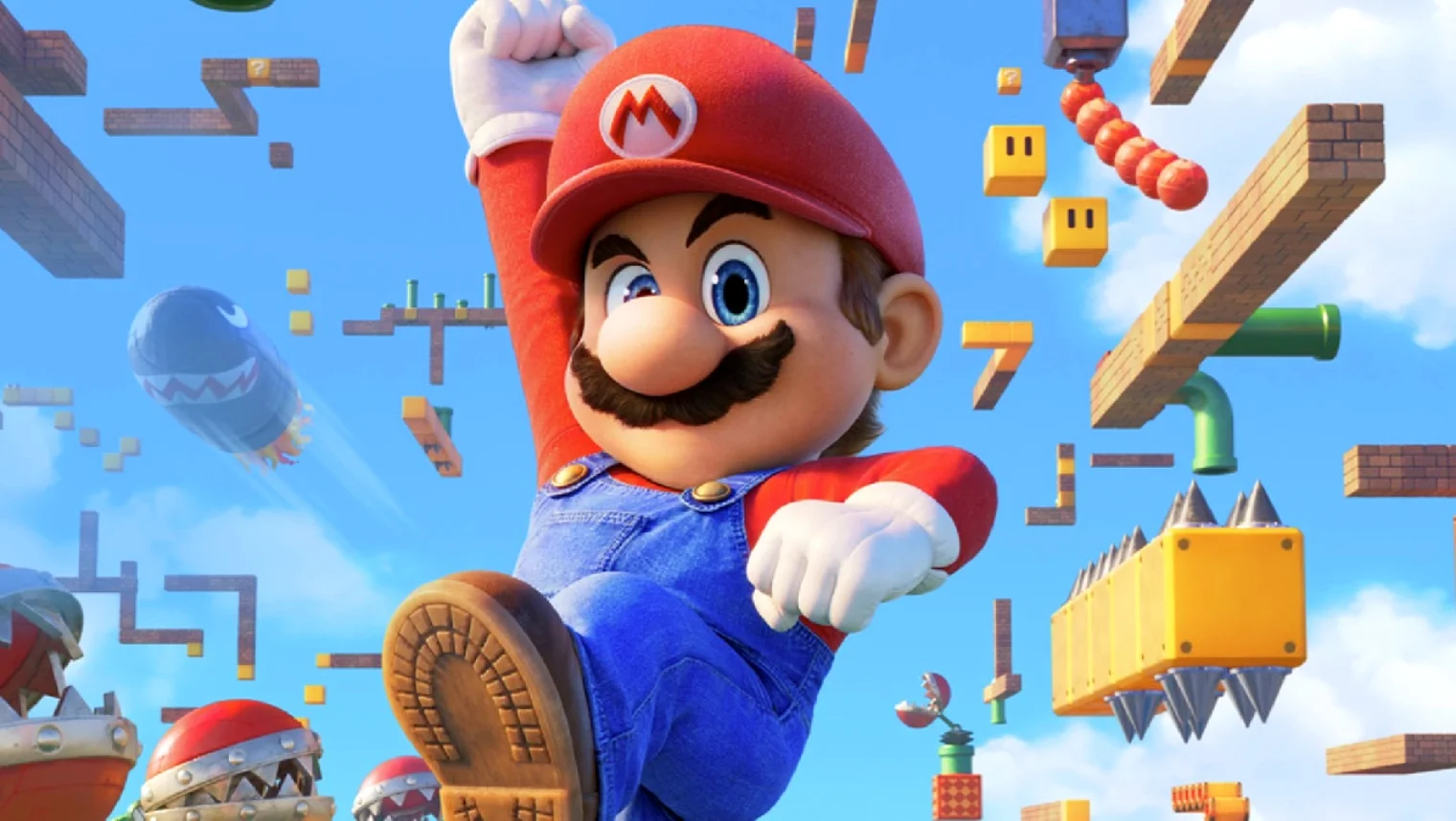 Mario salta em direção ao espectador em meio a um cenário flutuante repleto de elementos clássicos dos jogos, como blocos de interrogação, canos verdes, plantas carnívoras e um Bullet Bill sob um céu azul.