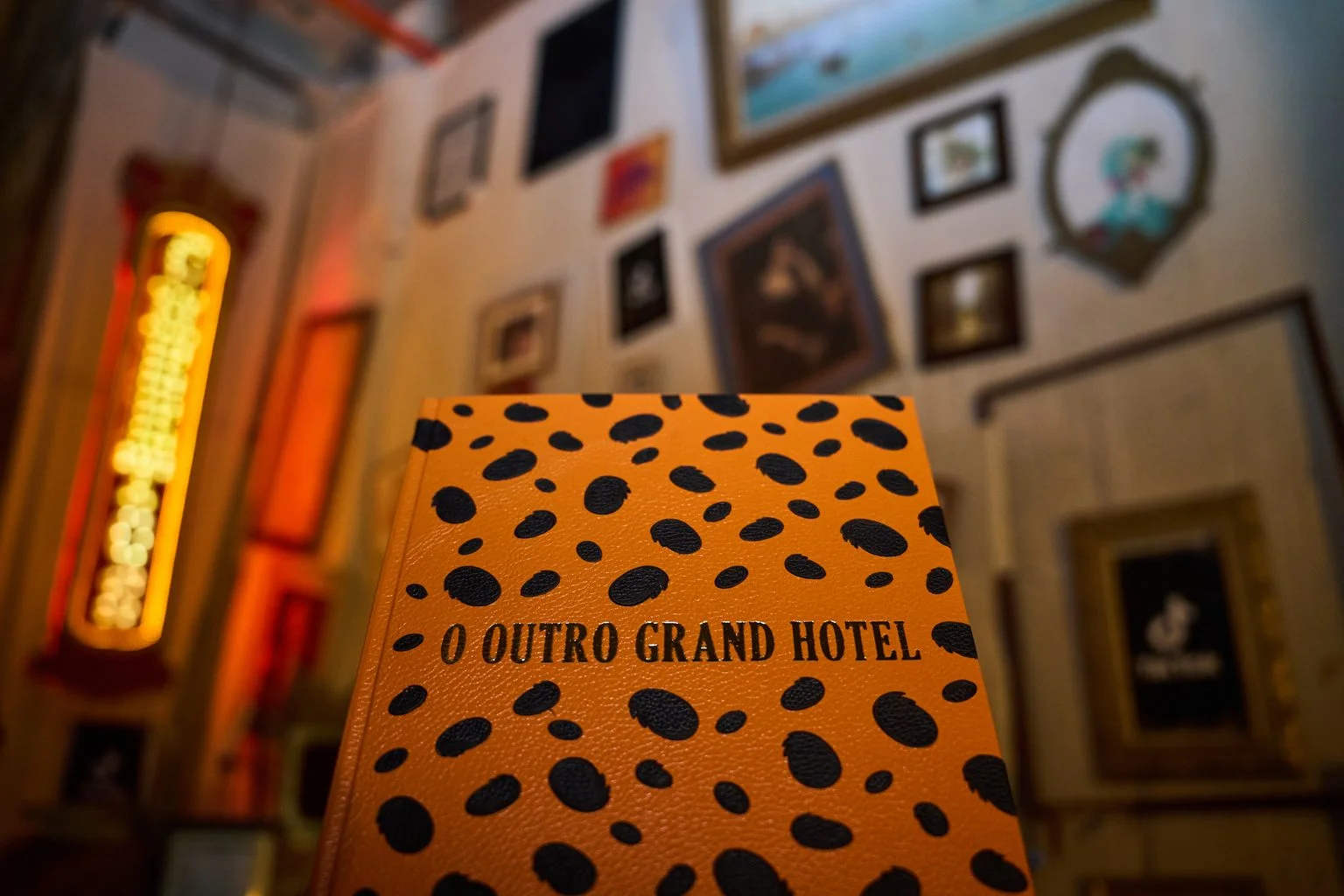 Livro laranja de O Outro Grand Hotel Cheetos em cenário imersivo de Halloween.