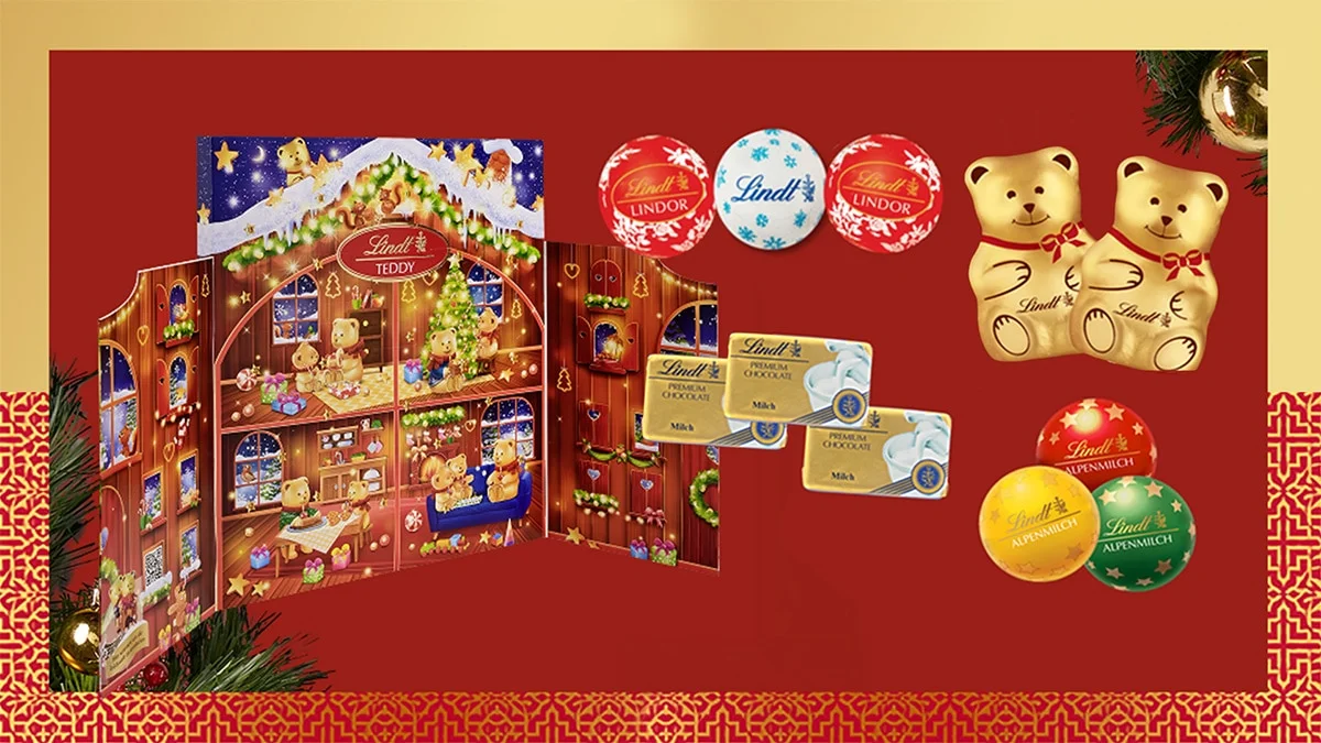 Calendário do Advento Lindt TEDDY aberto, com trufas LINDOR, chocolates e ursinhos de Natal.Calendário do Advento Lindt TEDDY aberto, com trufas LINDOR, chocolates e ursinhos de Natal.