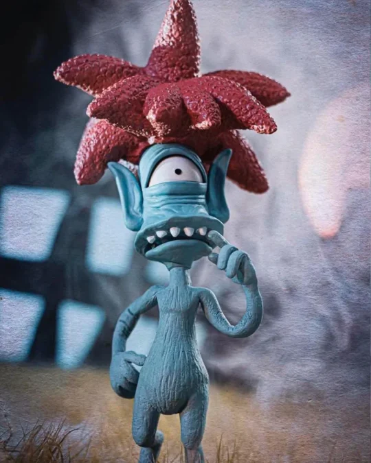 Personagem de cabelo vermelho e pele azul na abertura de Halloween dos Simpsons.